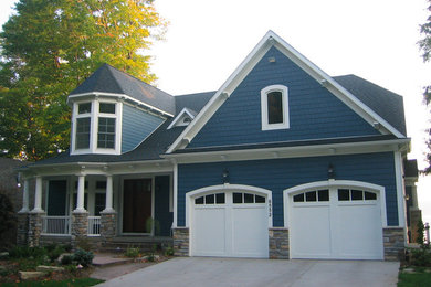 Inspiration for a large blue one-story stone exterior home remodel in Grand Rapids