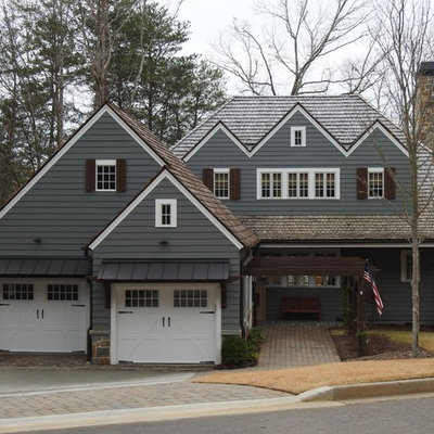 Large traditional gray two-story wood house exterior idea in Other with a hip roof and a shingle roof