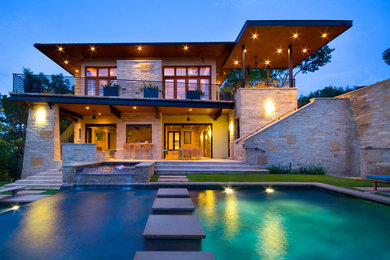 Large minimalist beige two-story stone flat roof photo in Austin