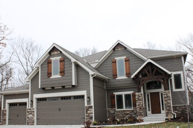 Large mountain style gray two-story wood exterior home photo in Kansas City