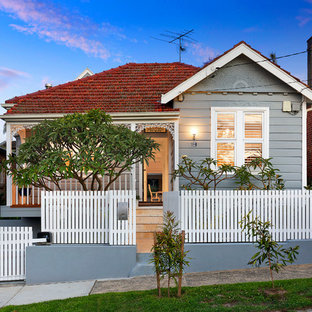 Inspiration for a mid-sized traditional one-storey grey house exterior in Sydney with a gable roof and a tile roof.