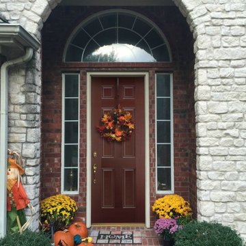Fall Decorated Entryway of a Traditional Style Home with a Bold Door