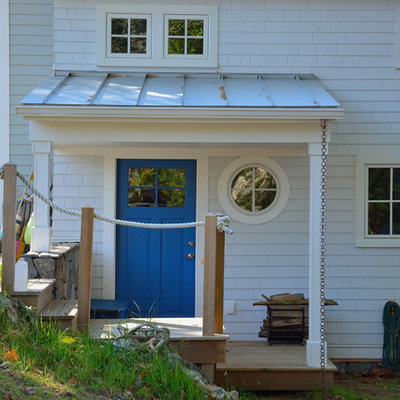Example of a large beach style blue two-story wood exterior home design in Portland Maine