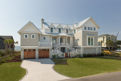 Large beach style beige three-story mixed siding exterior home photo in Charleston with a metal roof
