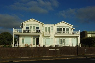 Inspiration for a large and white beach style two floor house exterior in Geelong with wood cladding.
