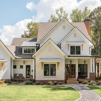 Example of a large farmhouse white two-story mixed siding exterior home design in Atlanta with a mixed material roof