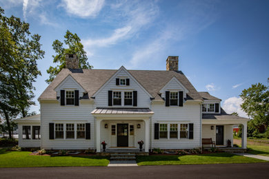 Large country white two-story wood exterior home photo in Boston with a shingle roof