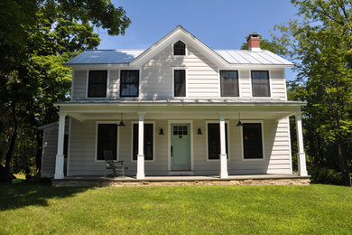 Example of a mid-sized white two-story wood exterior home design in New York