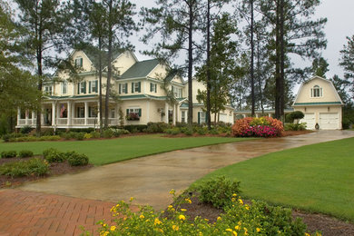 Example of a large farmhouse three-story wood exterior home design in Atlanta