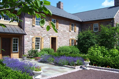 Example of a large country two-story stone exterior home design in Philadelphia