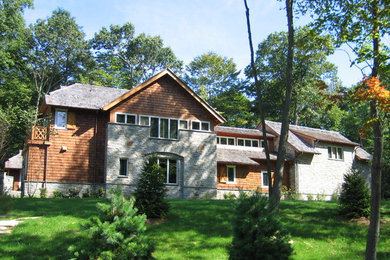 Ejemplo de fachada de casa gris tradicional grande de dos plantas con revestimientos combinados, tejado a dos aguas y tejado de teja de madera