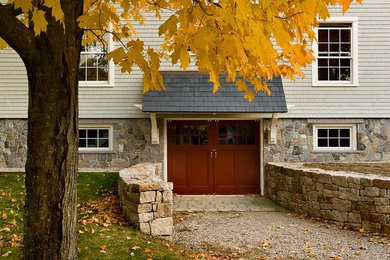 Large and green rural two floor house exterior in Boston with mixed cladding.