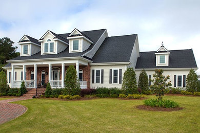 Inspiration for a large timeless beige two-story wood exterior home remodel in Other