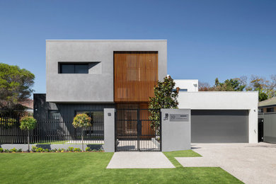 Imagen de fachada de casa multicolor contemporánea de tamaño medio de dos plantas con revestimientos combinados y tejado plano