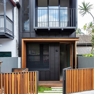 Photo of a mid-sized contemporary two-storey black house exterior in Sydney with metal siding.