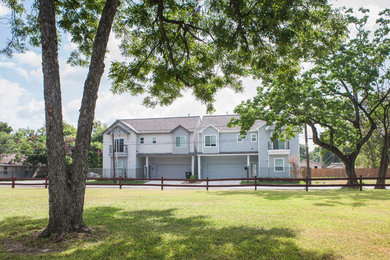 Mid-sized transitional gray two-story concrete fiberboard exterior home photo in Houston with a shingle roof
