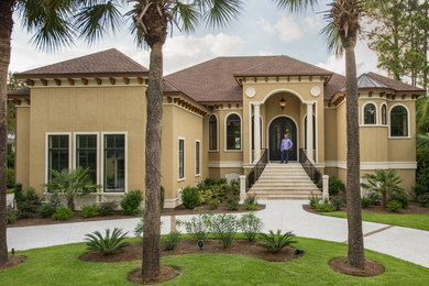 Example of a large tuscan beige two-story stucco exterior home design in Atlanta