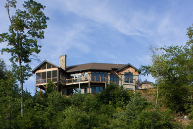 Example of a mid-sized mountain style exterior home design in Other