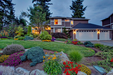 Large southwest gray two-story vinyl exterior home photo in Seattle with a hip roof