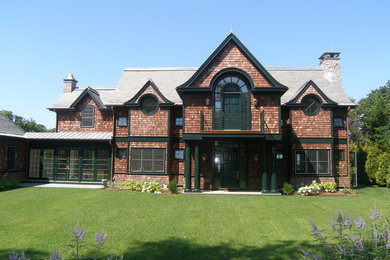 Example of a large classic brown two-story wood gable roof design in Bridgeport
