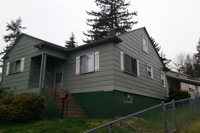 Example of a small classic green split-level mixed siding exterior home design in Seattle with a shingle roof