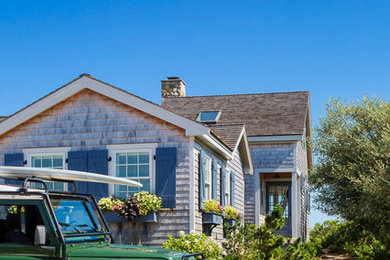 Inspiration for a small coastal two-story wood exterior home remodel in Boston with a shed roof