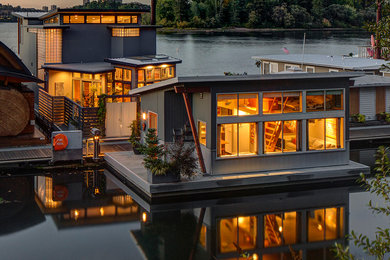 This is an example of a medium sized contemporary two floor house exterior in Portland with wood cladding.