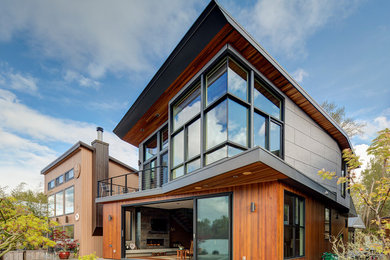 Mid-sized minimalist two-story wood exterior home photo in Portland with a shed roof