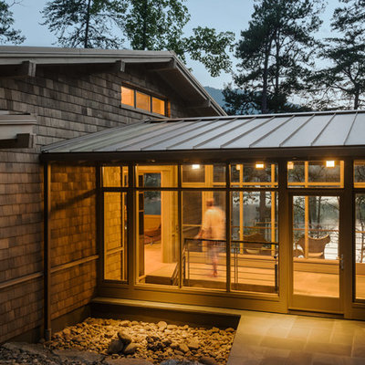 Inspiration for a mid-sized modern brown two-story wood exterior home remodel in Atlanta with a metal roof