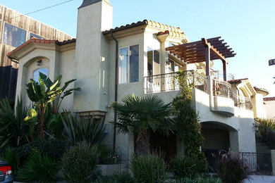 Inspiration for a medium sized and gey mediterranean render house exterior in Los Angeles with three floors.