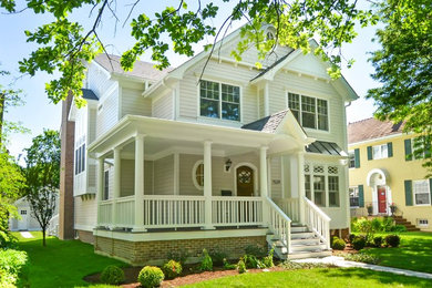 Example of a large transitional beige three-story mixed siding gable roof design in Chicago