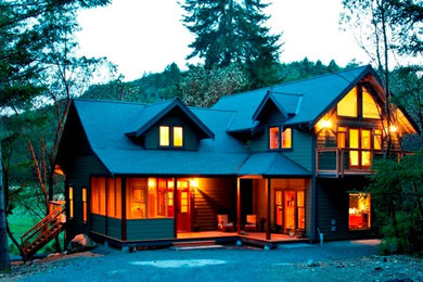Example of a classic green two-story concrete fiberboard gable roof design in Vancouver