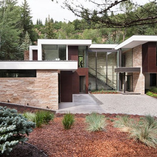 Example of a minimalist multicolored two-story mixed siding exterior home design in Other