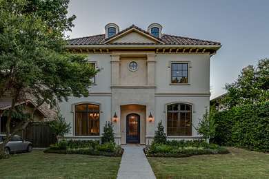 Large and white mediterranean house exterior in Dallas with three floors.
