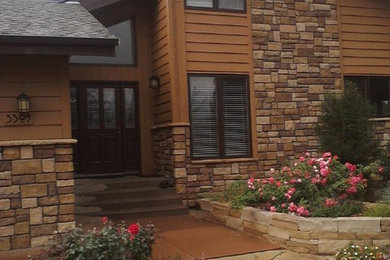 Example of a large mountain style brown two-story mixed siding exterior home design in Denver with a hip roof