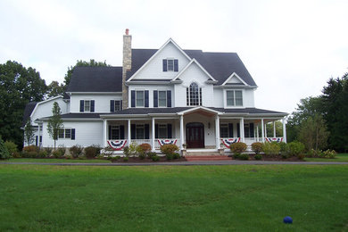 Large elegant white three-story wood house exterior photo in Chicago with a hip roof and a shingle roof