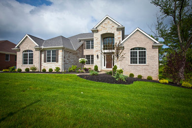Large transitional beige two-story brick exterior home photo in Cincinnati