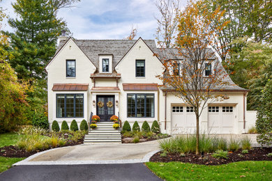 Inspiration for a large french country white two-story brick exterior home remodel in DC Metro with a shingle roof
