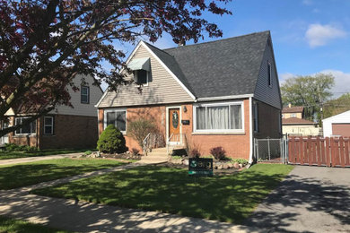 Mid-sized elegant gray two-story vinyl exterior home photo in Chicago with a shingle roof