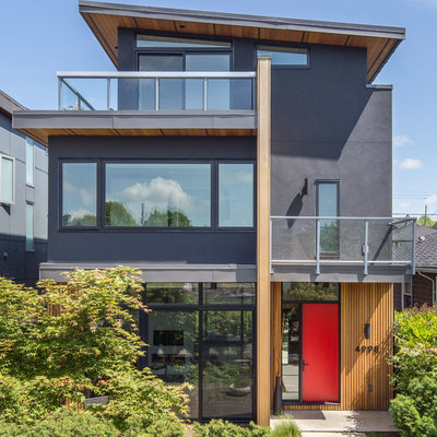 Inspiration for a mid-sized contemporary gray three-story mixed siding house exterior remodel in Vancouver with a shed roof