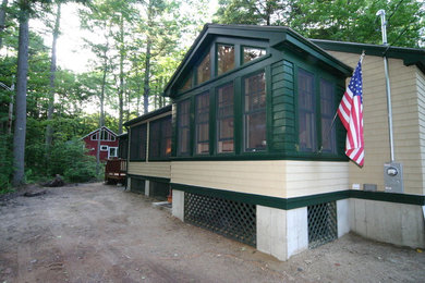 Craftsman green one-story wood exterior home idea in Portland Maine