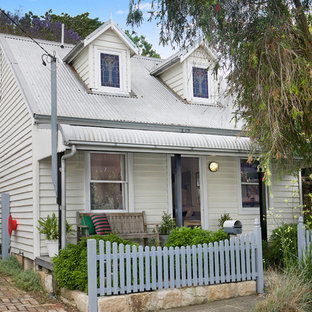 Inspiration for a traditional two-storey white house exterior in Sydney with a metal roof.
