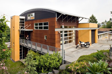 Photo of a medium sized and multi-coloured industrial house exterior in Seattle with mixed cladding and three floors.