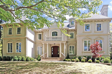 Inspiration for a huge craftsman beige two-story stucco gable roof remodel in New York