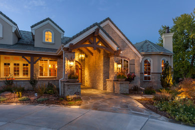 Inspiration for a timeless beige one-story stucco gable roof remodel in Denver