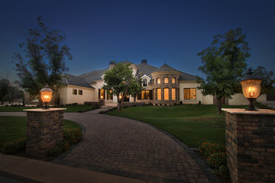 Example of a huge classic white one-story mixed siding house exterior design in Phoenix with a hip roof and a shingle roof