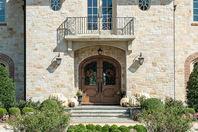 Example of a french country three-story stone exterior home design in New York