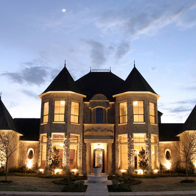 Inspiration for a large timeless beige two-story stone exterior home remodel in Dallas