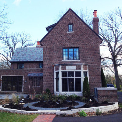 Example of a mid-sized classic three-story brick house exterior design in Chicago