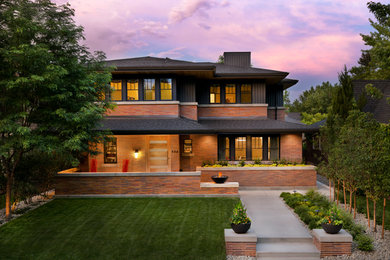 This is an example of a traditional two floor house exterior in Denver with mixed cladding and a hip roof.